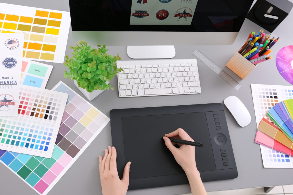 Young designer drawing sketches on graphic tablet, closeup